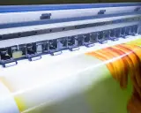 La stampante industriale crea un'immagine vibrante su un supporto in formato 3:2.