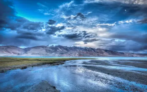 Paesaggio montano con lago e cielo drammatico. L'effetto HDR esalta i colori e i dettagli, un sì deciso per questa immagine.