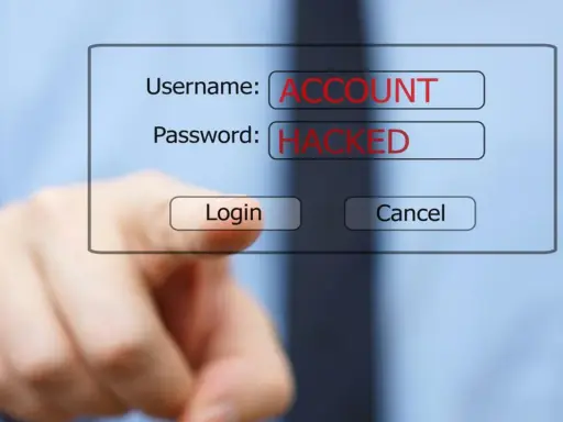 Dito, un dito punta verso un form di login dove "ACCOUNT" e "HACKED" sono scritti in rosso. Le foto rubate sono un rischio.